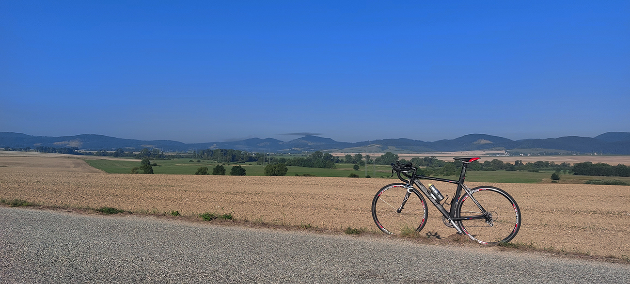Napriek_dojmu_„cezpoľnosti“_je_cesta_široká,_zväčša_rovná._Vpravo_pod_mrakom_Vyšehrad.